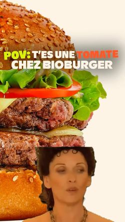 Burger bio avec un pain doré, légumes frais et steak juteux, offrant options vegan et végétarien.